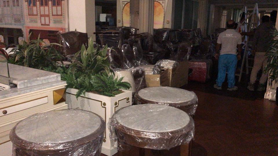 Restaurant furniture wrapped in plastic and stacked for removal at Capitol Piazza