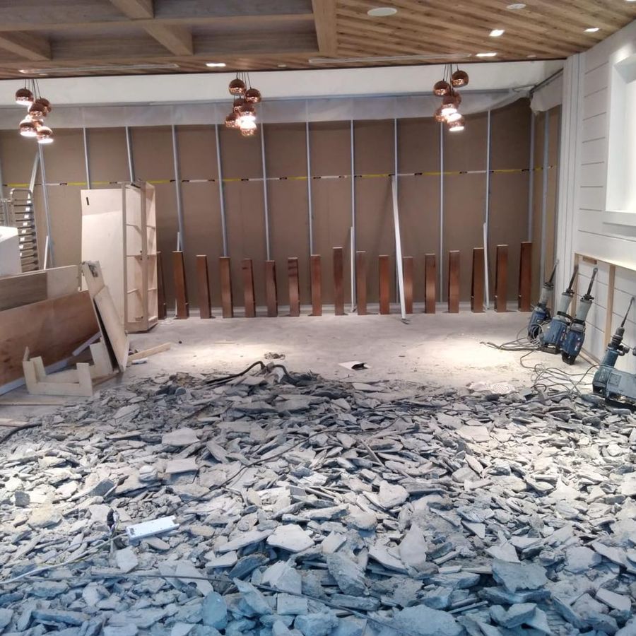 Floor tiles broken up and wall panels stripped inside a unit at Bugis Junction