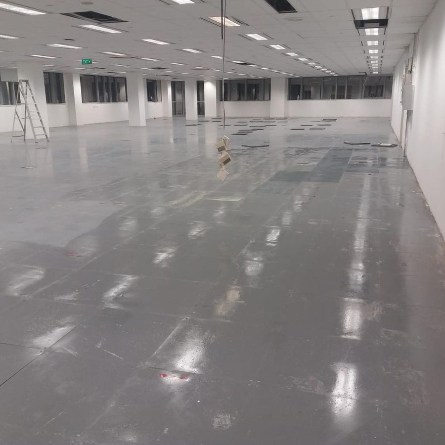 A cleared unit at Central Mall with bare walls and a polished floor, ready for handover