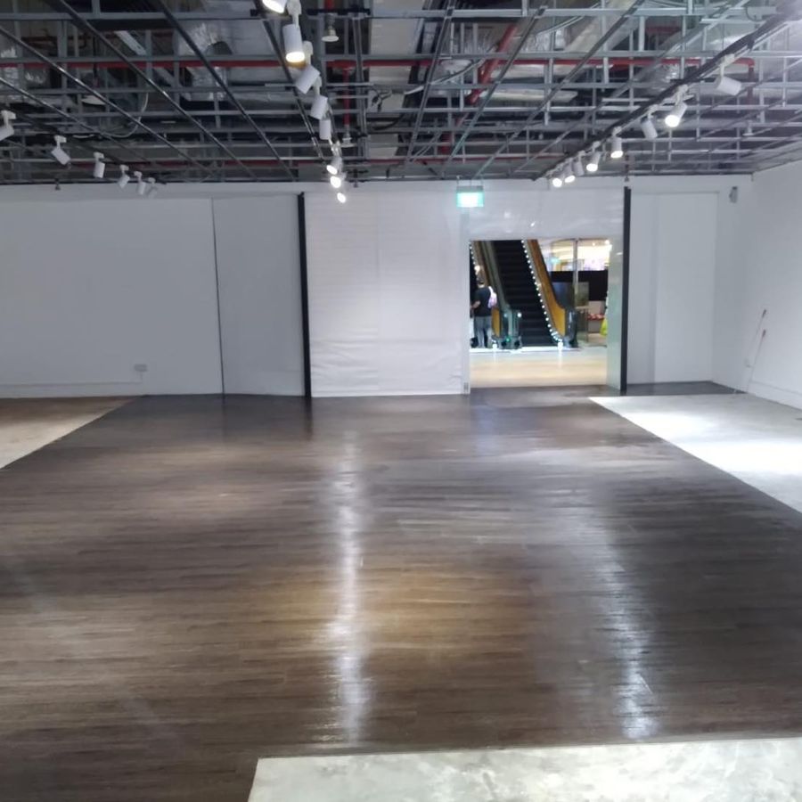 An empty unit at Century Square with the ceiling opened up and the floor cleared after reinstatement