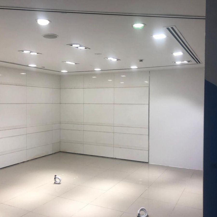A cleared unit at Orchard Gateway with white walls and downlights, ready for handover