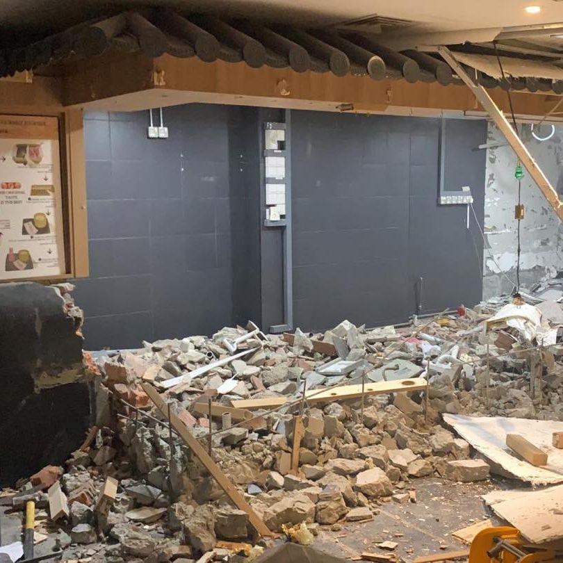 Counters and wall finishes being demolished in an F&B outlet at Raffles City